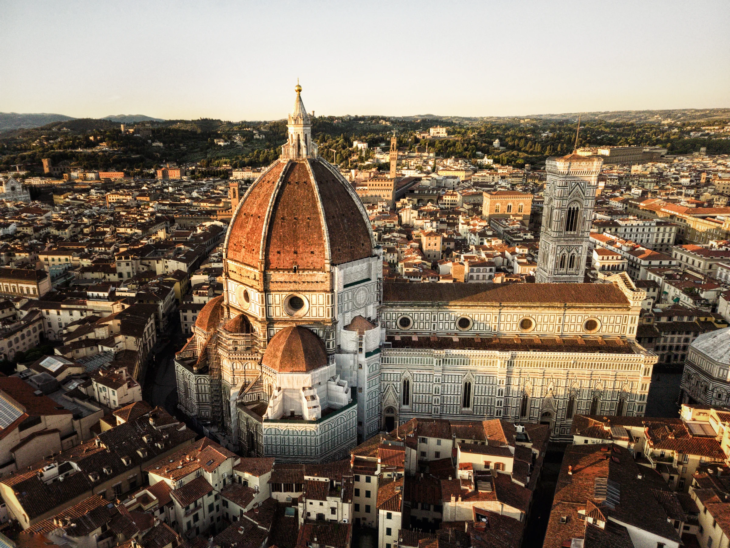 There's a strong chance this image contains the following subjects: architecture,  travel,  city,  church,  cathedral. The photographer has provided the following description: I took this picture at 06:00 AM in morning to capture this majestic and beautiful cathedral in Florence in the early morning glow Photographer_name: Taha Masood. Title: FLORENCE AT SUNRISE. The photographer has provided the following description: I took this picture at 06:00 AM in morning to capture this majestic and beautiful cathedral in Florence in the early morning glow Make: dji. Model: Mini 3 pro. Published: 2025-09-27 14:47:30