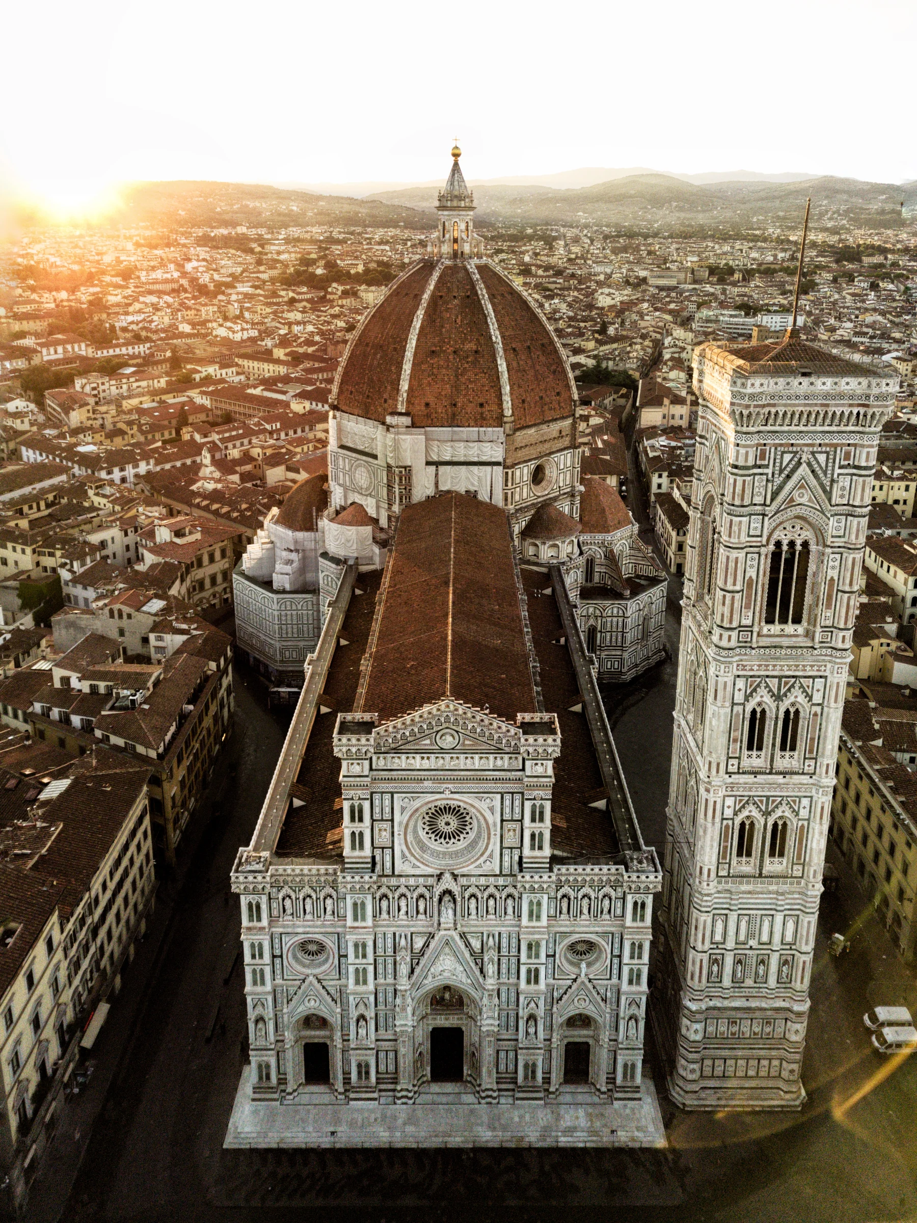 There's a strong chance this image contains the following subjects: architecture,  travel,  city,  church,  cathedral. The photographer has provided the following description: Santa Maria cathedral basking in early morning glow Photographer_name: Taha Masood. Title: Santa Maria duomo Del fiore, Florence. The photographer has provided the following description: Santa Maria cathedral basking in early morning glow Make: dji. Model: Mini 3 pro. Published: 2025-09-27 14:45:16