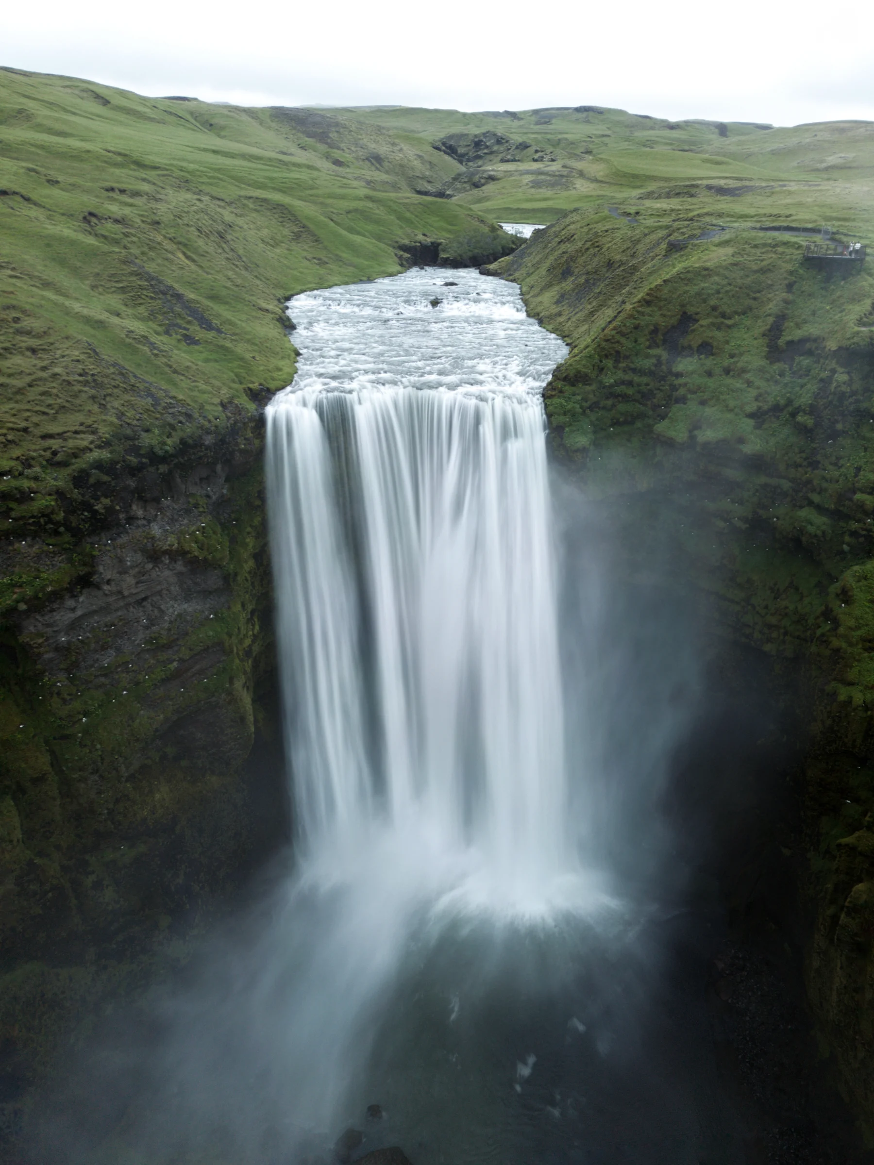 There's a strong chance this image contains the following subjects: water,  landscape,  travel,  mist,  fall,  nature,  river,  waterfall. The photographer has provided the following description: The majestic skogafoss, iceland at 01:00 AM during midnight sun Photographer_name: Taha Masood. Title: Skogafoss, iceland. The photographer has provided the following description: The majestic skogafoss, iceland at 01:00 AM during midnight sun Make: dji. Model: Mini 3 pro. Technical: Long exposure, tripod mode
ND16. Published: 2025-09-01 08:00:31
