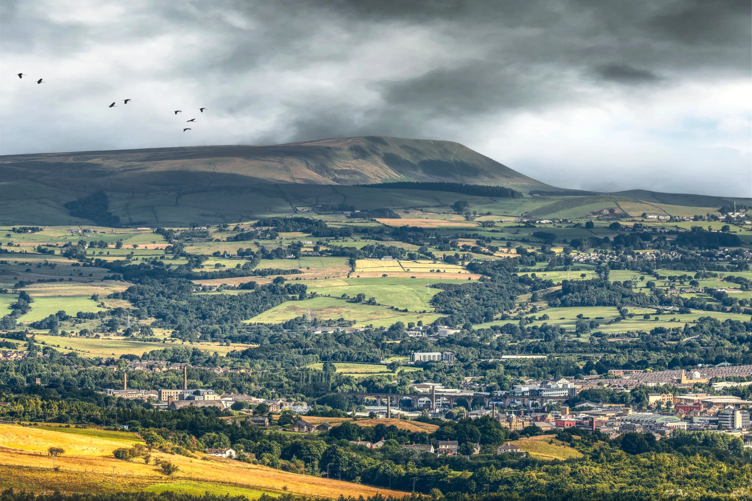 There's a strong chance this image contains the following subjects: sky,  landscape,  travel,  nature,  cropland,  lancashire. The photographer has provided the following description: As seen from the Singing Ringing Tree Photographer_name: Chris Michael. Title: Burnley. The photographer has provided the following description: As seen from the Singing Ringing Tree Make: canon. Model: EOS R. Technical: RF70-200mm. Published: 2025-09-05 19:49:42