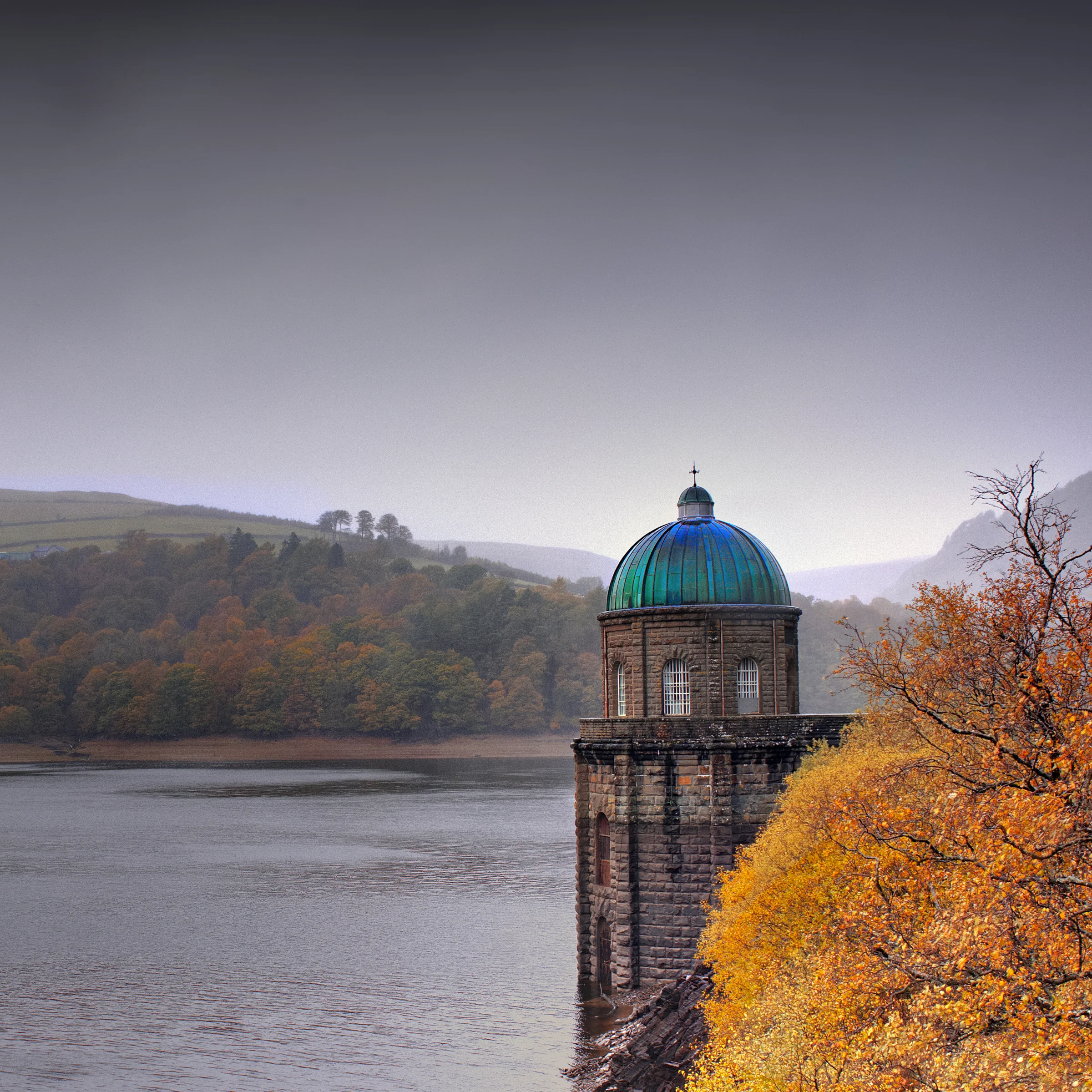 There's a strong chance this image contains the following subjects: architecture,  sky,  water,  sunset,  wales,  autumn,  craiggoch,  craiggochdam,  elanvalley,  powys,  dam. The photographer has provided the following description: The tower at Craig Goch Dam in Mid-Wales Photographer_name: Chris Michael. Title: Autumn in Elan Valley. The photographer has provided the following description: The tower at Craig Goch Dam in Mid-Wales Make: canon. Model: EOS R. Technical: 16mm. Published: 2025-09-09 13:54:46