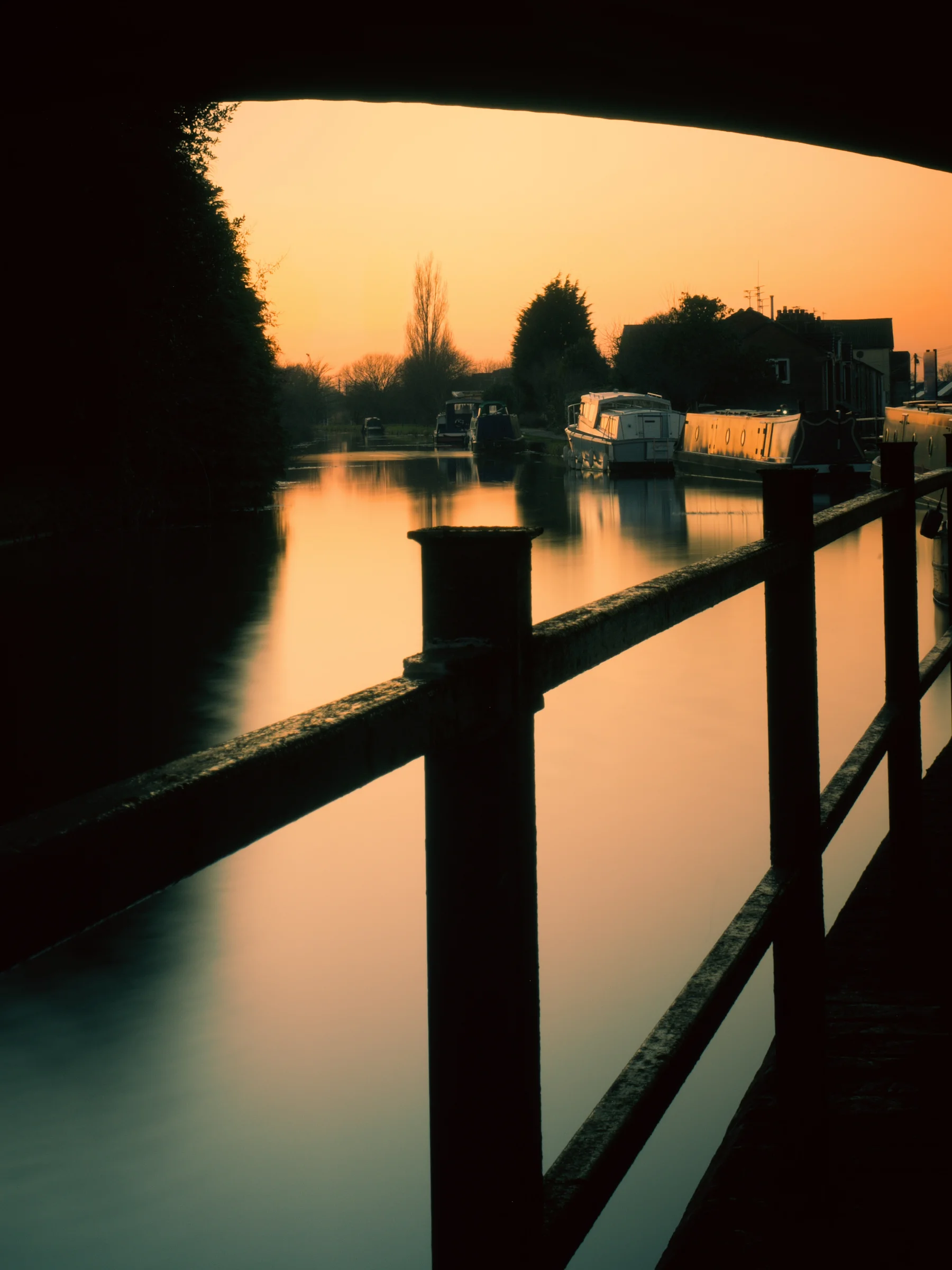 There's a strong chance this image contains the following subjects: water,  lake,  sunset,  dawn,  river,  reflection,  lancashire,  sun,  bridge,  burscough,  dusk. The photographer has provided the following description: I was told there'd be an epic sunset near where I live. I wasn't disappointed! The sky lit up bright orange along the Leeds-Liverpool Canal. Photographer_name: Chris Michael. Title: Burscough Wharf. The photographer has provided the following description: I was told there'd be an epic sunset near where I live. I wasn't disappointed! The sky lit up bright orange along the Leeds-Liverpool Canal. Make: fujifilm. Model: X-T5. Technical: Fuji XF16-80mm. Published: 2025-09-05 19:30:13