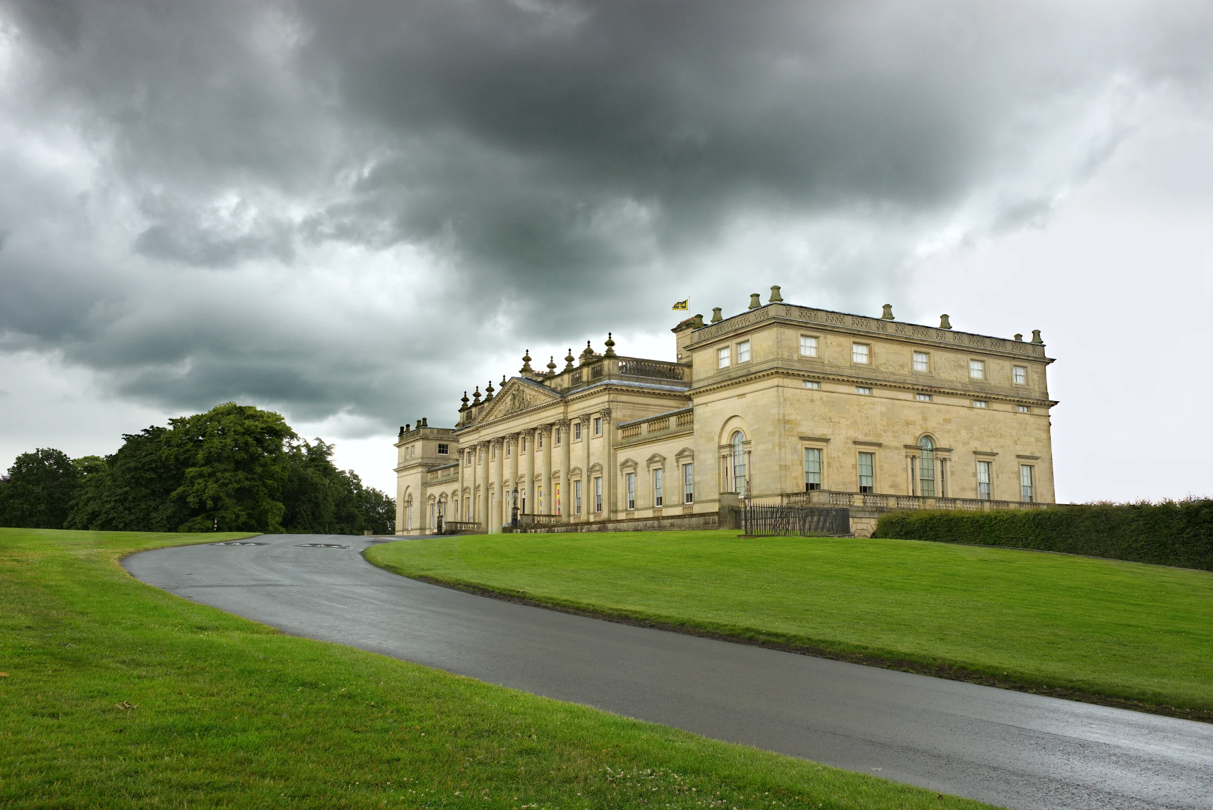 There's a strong chance this image contains the following subjects: house,  architecture,  sky,  travel,  building,  yorkshire,  castle. The photographer has provided the following description: The winding road through the Harewood Estate in Leeds. Photographer_name: Chris Michael. Title: Harewood House. The photographer has provided the following description: The winding road through the Harewood Estate in Leeds. Make: fujifilm. Model: X-T5. Technical: 16-80mm. Published: 2025-09-07 22:45:18