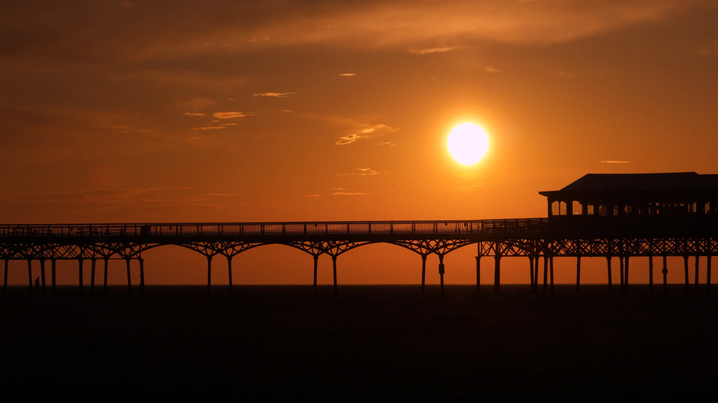 There's a strong chance this image contains the following subjects: water,  sea,  sunset,  dawn,  beach,  lancashire,  sun,  bridge,  ocean,  silhouette,  lytham,  lythamstannes,  pier. The photographer has provided the following description: Sunset time, just above the Pier at Lytham St Annes in Lancashire. Photographer_name: Chris Michael. Title: Lytham St Annes Pier. The photographer has provided the following description: Sunset time, just above the Pier at Lytham St Annes in Lancashire. Make: fujifilm. Model: X-T5. Technical: XF16-80mm. Published: 2025-09-06 19:06:45
