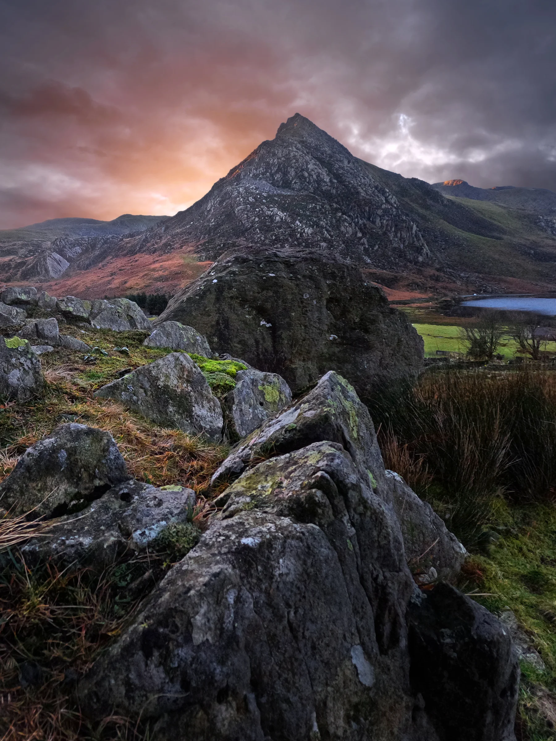 There's a strong chance this image contains the following subjects: sky,  landscape,  travel,  rock,  nature,  wales,  snowdonia,  eryri,  eryrinationalpark,  nationalpark,  snowdon,  tryfan. The photographer has provided the following description: This is the mighty Tryfan in Wales. Taken just moments before sunrise a couple of Winter's ago! Photographer_name: Chris Michael. Title: Tryfan Sunrise. The photographer has provided the following description: This is the mighty Tryfan in Wales. Taken just moments before sunrise a couple of Winter's ago! Make: fujifilm. Model: X-T5. Technical: 16-80mm. Published: 2025-09-09 16:38:04