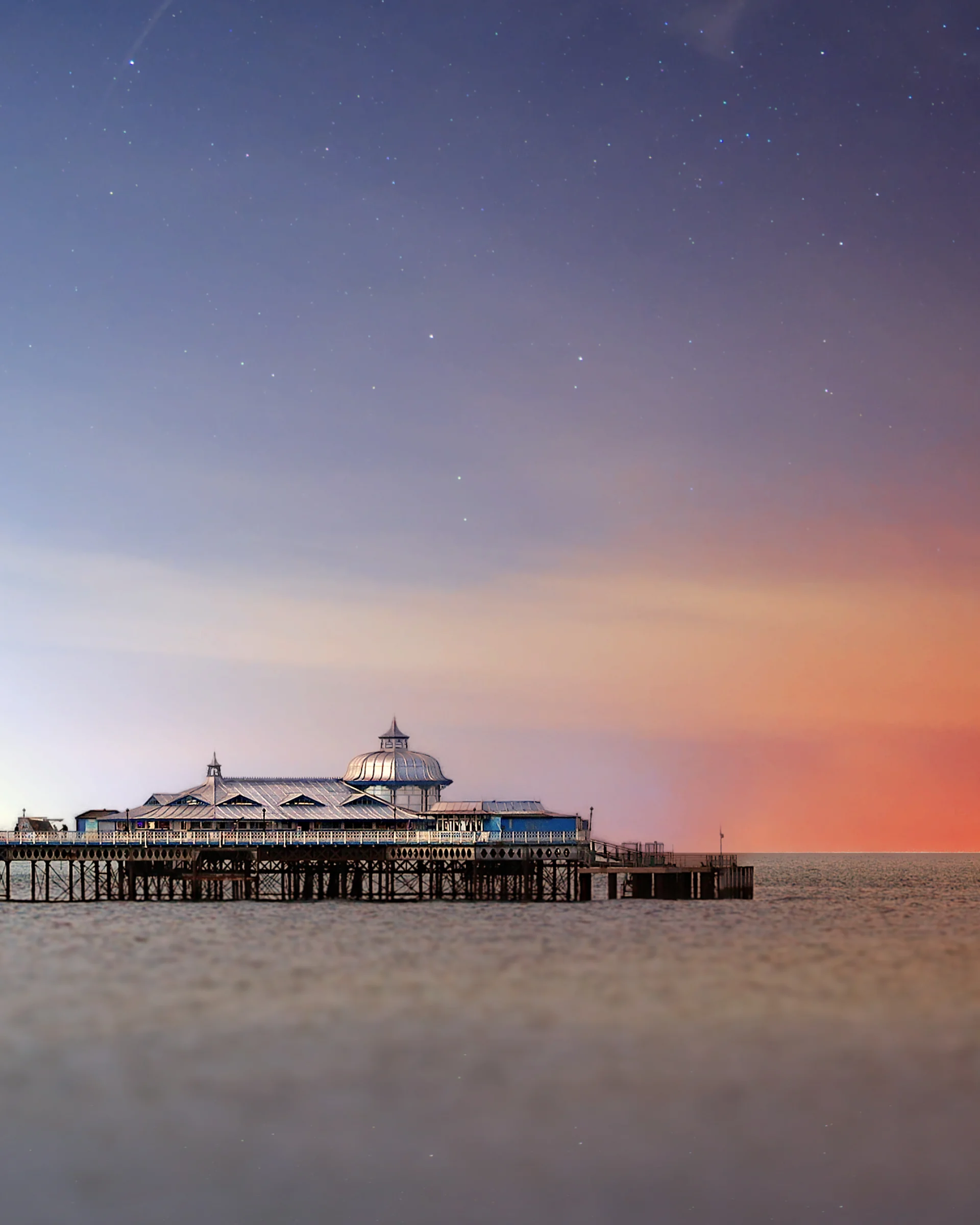 There's a strong chance this image contains the following subjects: sky,  water,  landscape,  travel,  sea,  sunset,  sun,  ocean,  stars,  milkyway,  pier,  seascape,  wales. The photographer has provided the following description: Sunset in Llandudno Photographer_name: Chris Michael. Title: Llandudno Pier. The photographer has provided the following description: Sunset in Llandudno Make: canon. Model: EOS R. Technical: 70-200mm. Published: 2025-09-09 13:41:34