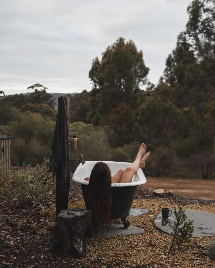 There's a strong chance this image contains the following subjects: landscape,  people,  nature,  hotel,  woman,  relaxation. FOTO has this to say about the photograph: This photograph beautifully captures a moment of solitude and serenity, with earthy tones and subtle detail create a grounded calm, while the positioning suggests a quiet luxury, bathing not just in water, but in nature itself. Source: https://www.instagram.com/stillwood.retreat/ Photographer_name: Stillwood Retreat. Title: Dreamy Escape. FOTO has this to say about the photograph: This photograph beautifully captures a moment of solitude and serenity, with earthy tones and subtle detail create a grounded calm, while the positioning suggests a quiet luxury, bathing not just in water, but in nature itself. Published: 2025-06-23 13:52:14