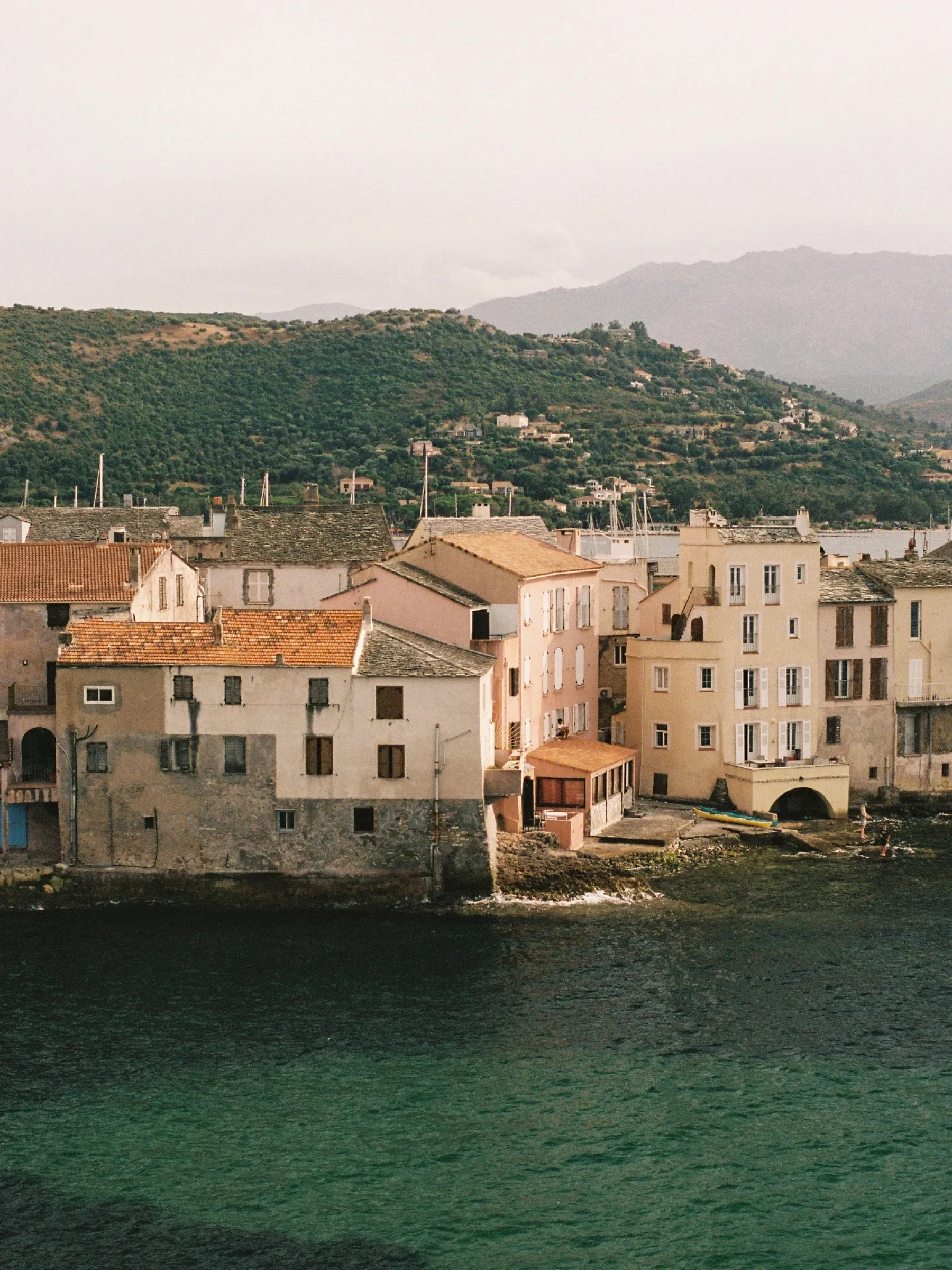 There's a strong chance this image contains the following subjects: architecture,  water,  travel,  city. Source: https://www.instagram.com/natsbfilm/ Photographer_name: Natacha. Title: Saint Florent. Published: 2025-10-12 12:34:59