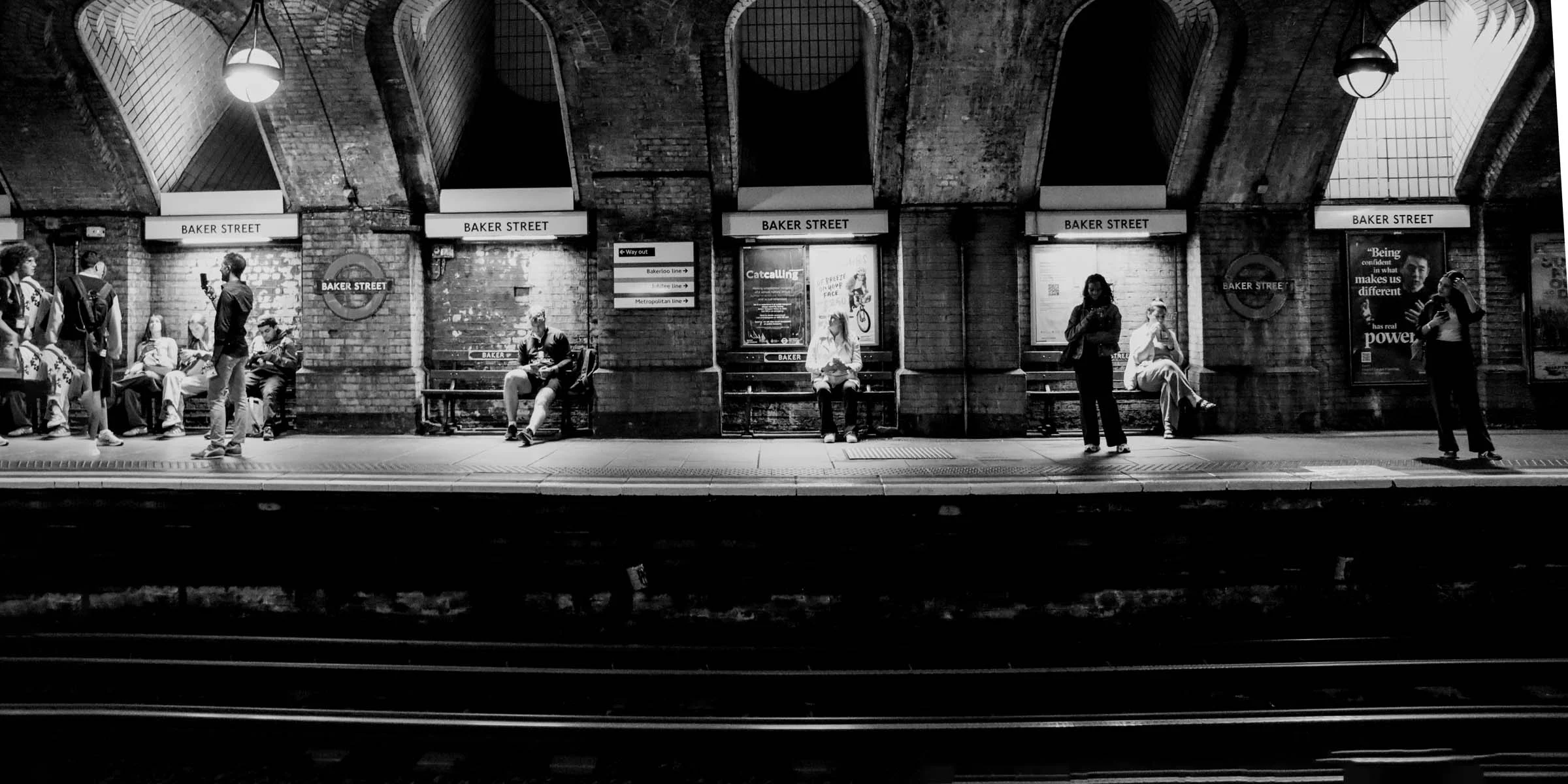 There's a strong chance this image contains the following subjects: street,  monochrome,  city,  people,  man. FOTO has this to say about the photograph: Captures a wonderful scene of London's commuters Photographer_name: Paul Miller. Title: Baker Street Station. Make: canon. Model: EOS 90D. FOTO has this to say about the photograph: Captures a wonderful scene of London's commuters Published: 2025-08-27 20:45:00