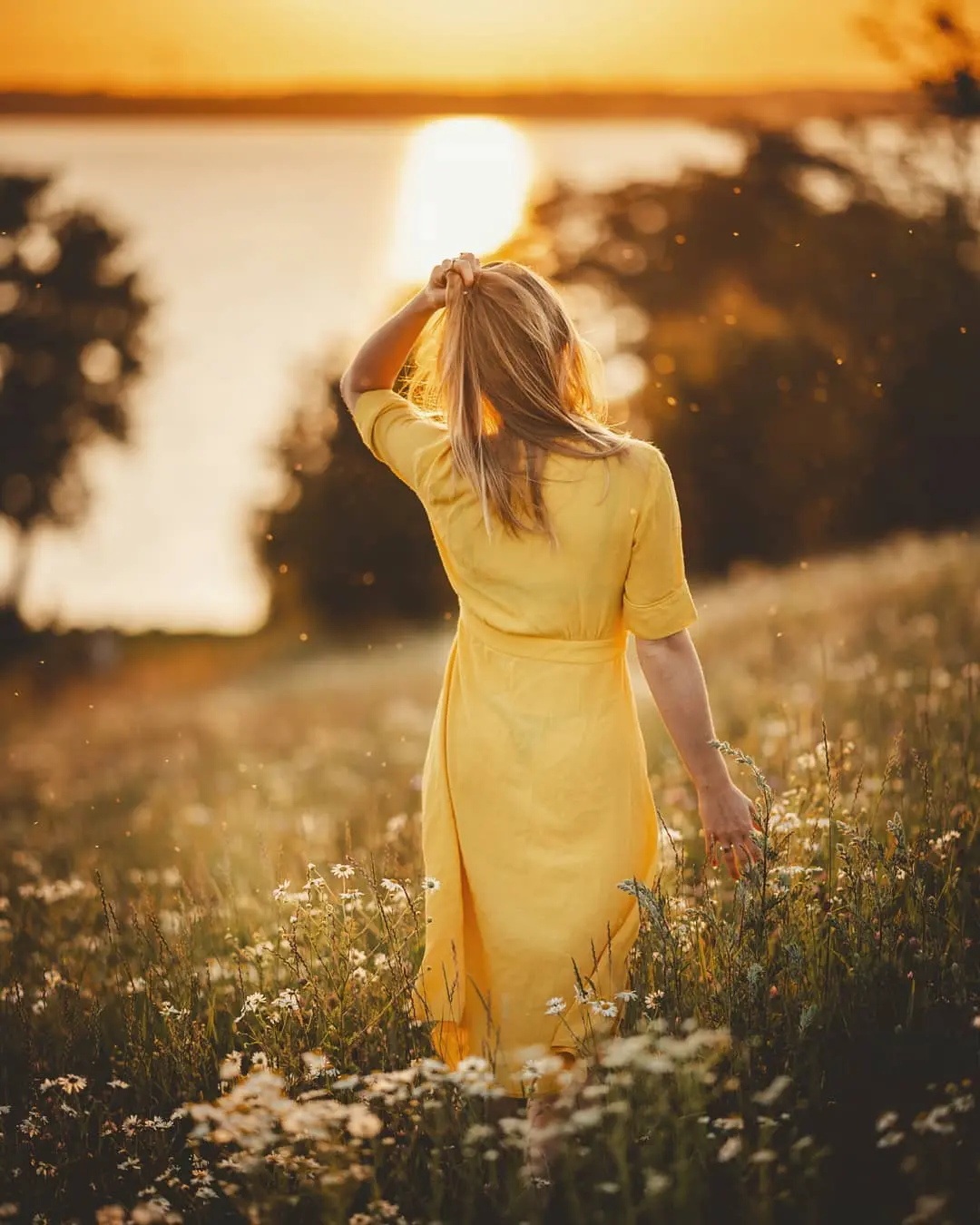 There's a strong chance this image contains the following subjects: people,  sunset,  fall,  nature,  woman,  fashion,  portrait,  model,  summer,  sun. The photographer has provided the following description: Nikon Z6, Nikkor 105mm f.1/4 FOTO has this to say about the photograph: This photograph offers a quiet, sunlit intimacy, with the subject caught mid-thought in a moment of natural ease. The composition is gentle and uncluttered, drawing attention to soft lines, light play, and the calm confidence in her expression. It feels spontaneous yet composed. like a breath held in golden light. Source: https://www.instagram.com/dennis_visuals/ Photographer_name: DES. Title: The last summer days are almost over. The photographer has provided the following description: Nikon Z6, Nikkor 105mm f.1/4 FOTO has this to say about the photograph: This photograph offers a quiet, sunlit intimacy, with the subject caught mid-thought in a moment of natural ease. The composition is gentle and uncluttered, drawing attention to soft lines, light play, and the calm confidence in her expression. It feels spontaneous yet composed. like a breath held in golden light. Published: 2025-06-25 09:15:19