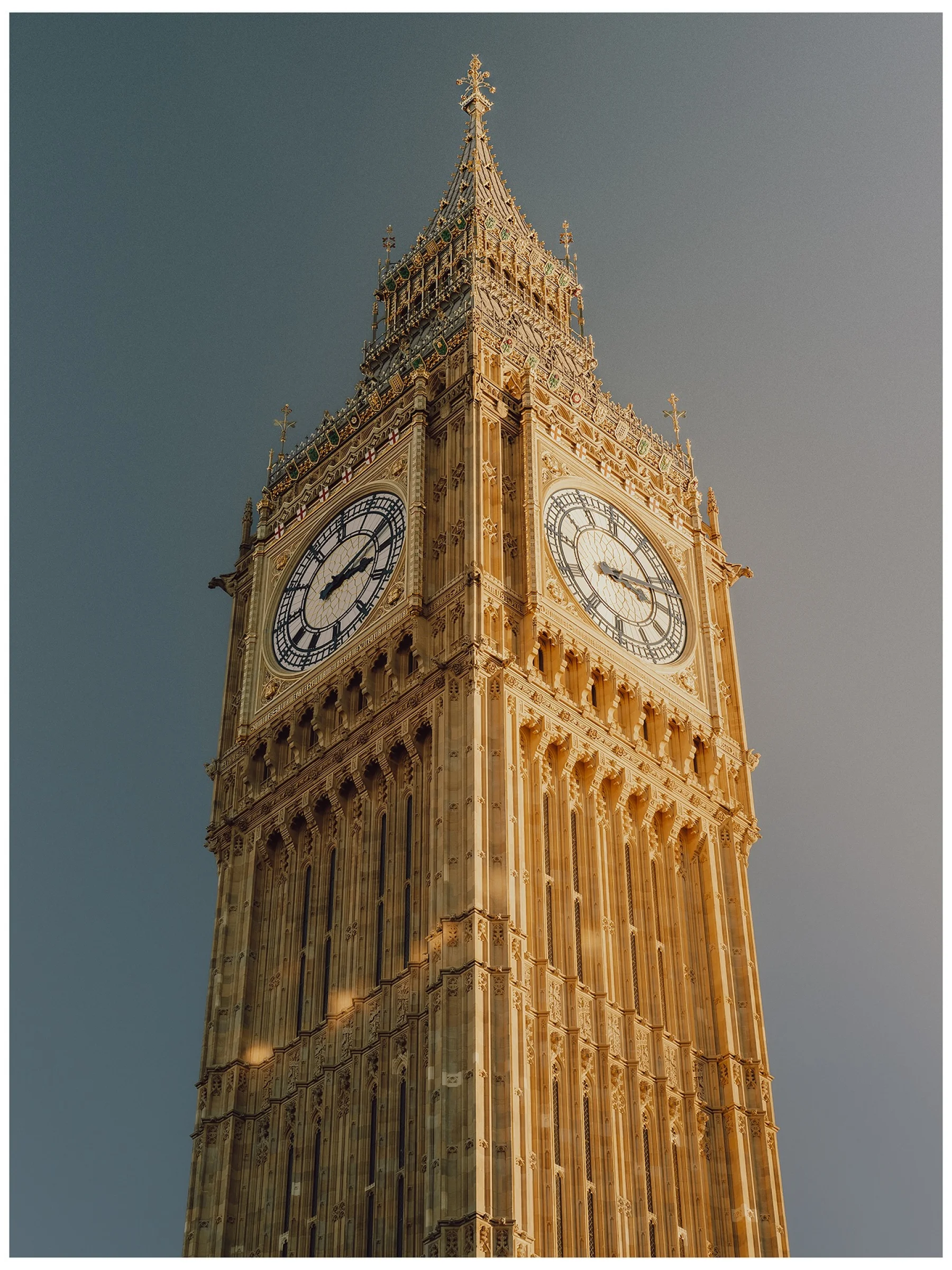 There's a strong chance this image contains the following subjects: architecture,  travel,  city,  clock,  tower. The photographer has provided the following description: When we think of autumn, it’s easy to picture woodlands and valleys, misty hills and drifting fog. But cities change too.

London in autumn is softer at the edges, light falling lower between buildings, pavements scattered with leaves, people wrapped in coats and layers as the air turns cool. Source: https://www.instagram.com/withgar/ Photographer_name: Gareth Llewellyn. Title: Autumn Light in London. The photographer has provided the following description: When we think of autumn, it’s easy to picture woodlands and valleys, misty hills and drifting fog. But cities change too.

London in autumn is softer at the edges, light falling lower between buildings, pavements scattered with leaves, people wrapped in coats and layers as the air turns cool. Make: sony. Model: a7R V. Published: 2025-10-12 09:39:42