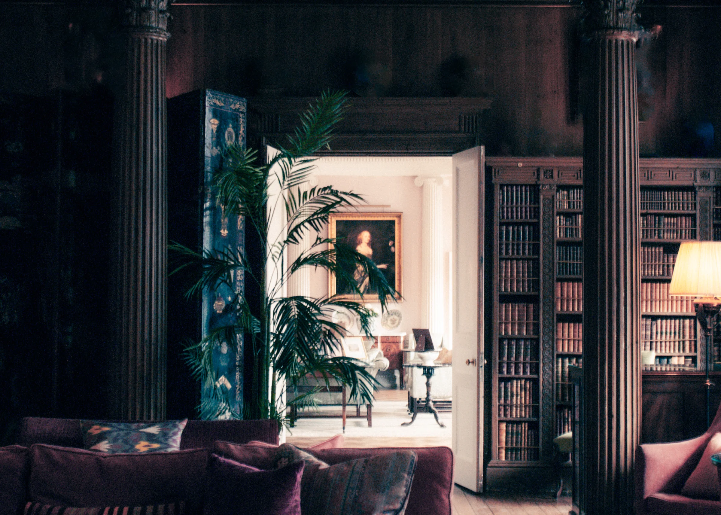 There's a strong chance this image contains the following subjects: indoors,  furniture. The photographer has provided the following description: Through the darkness there is light, and it shines on Miss Elizabeth at Weston Park. The contrast between these two rooms is striking, making for such wonderful framing of this painting. Photographer_name: Lee Sillery. Title: Miss Elizabeth. The photographer has provided the following description: Through the darkness there is light, and it shines on Miss Elizabeth at Weston Park. The contrast between these two rooms is striking, making for such wonderful framing of this painting. Make: sony. Model: a300. Technical: 18-70mm f8, 800 ISO 1/13. Published: 2025-09-12 20:14:33