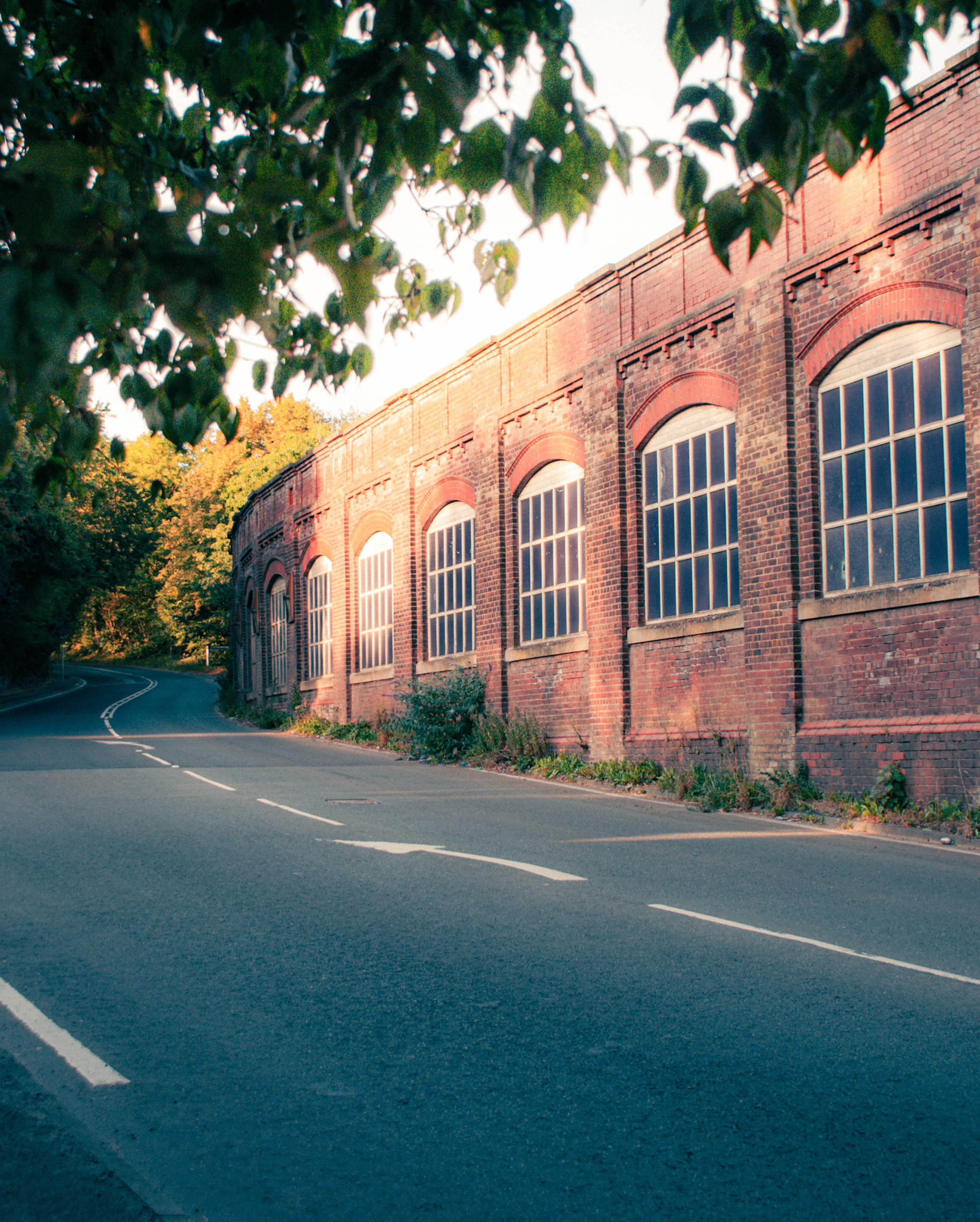 There's a strong chance this image contains the following subjects: architecture,  street,  road. The photographer has provided the following description: The old bleach works in Standish, Wigan. Photographer_name: Lee Sillery. Title: Still Chasing Golden Hour. The photographer has provided the following description: The old bleach works in Standish, Wigan. Make: sony. Model: a300. Technical: 18-70mm. 1/40 f5 ISO 100. Published: 2025-08-17 21:18:09